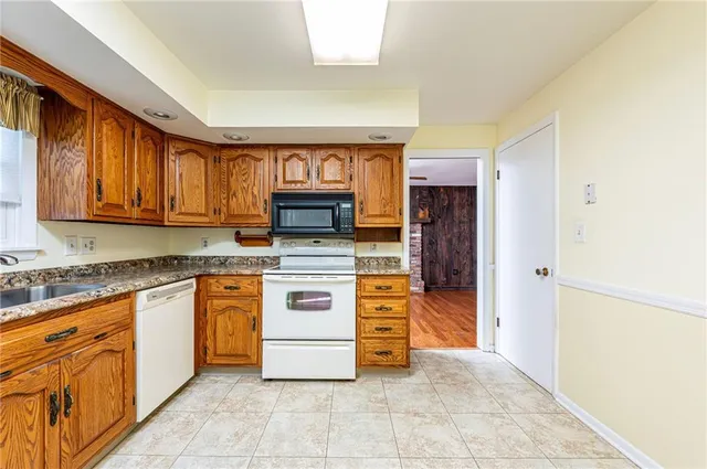 a kitchen with stainless steel appliances granite countertop a stove and a sink