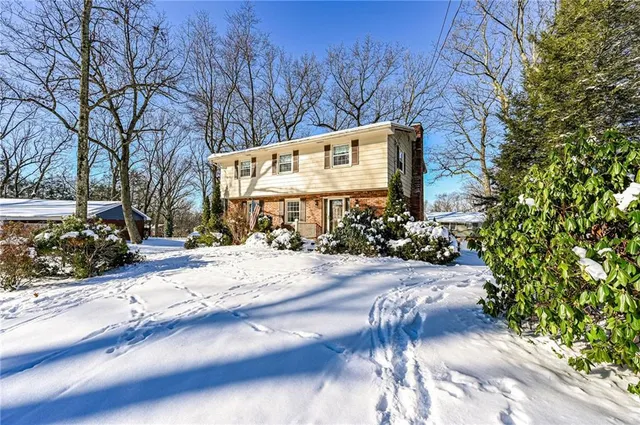 a sign board with yard and car parked