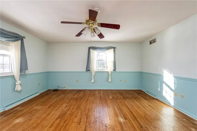wooden floor in an empty room with a window