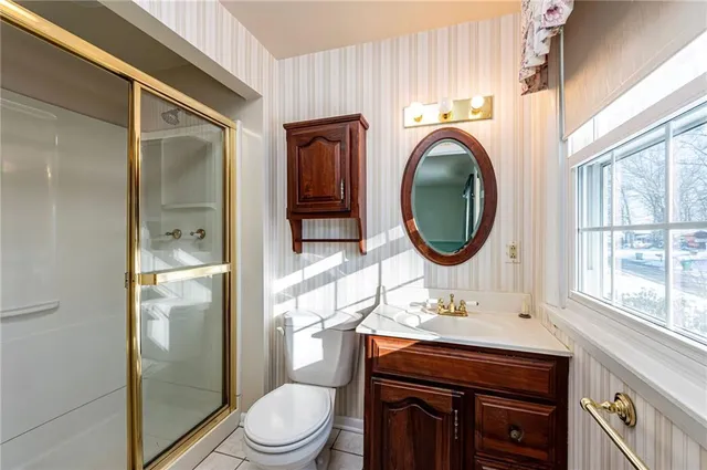 a bathroom with a toilet a sink and mirror