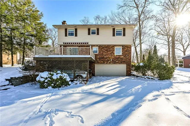 a front view of a house with a yard and a garage