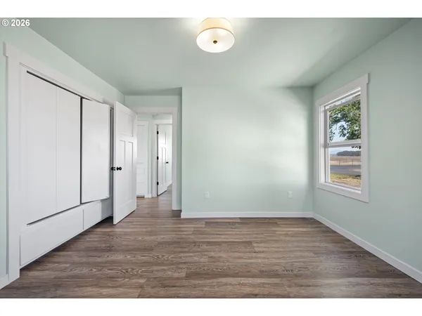 a view of room with window and wooden floor
