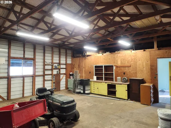 a room with furniture storage and a flat screen tv