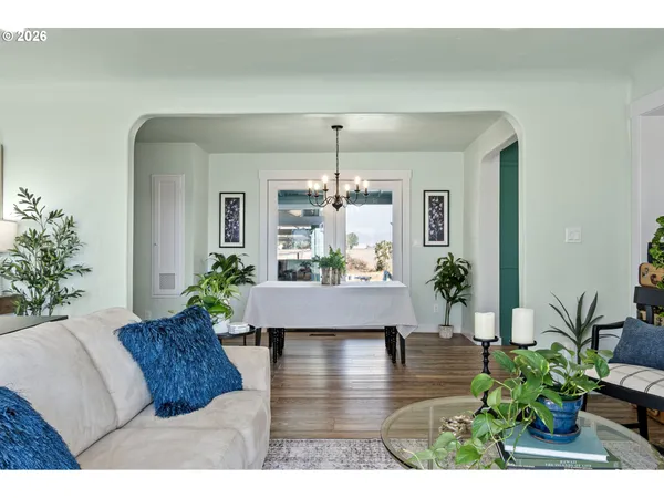 a living room with furniture and a chandelier