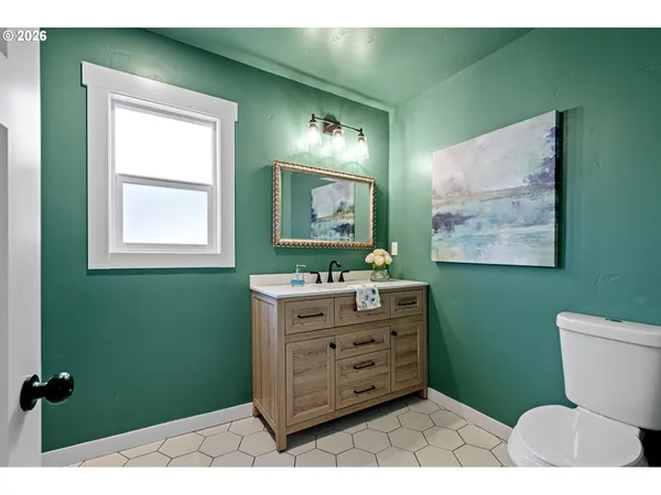 a bathroom with a toilet sink and mirror