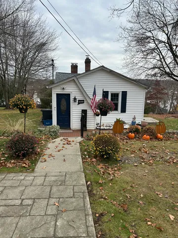 a backyard of a house with yard and outdoor seating