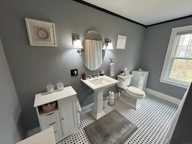 a bathroom with a sink mirror and vanity