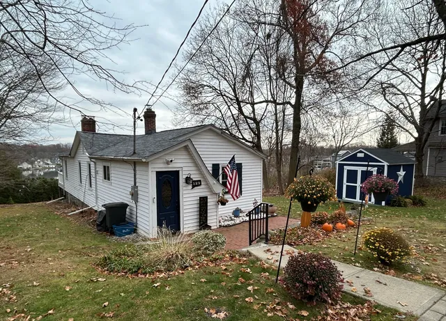 a view of a house with a yard covered in snow