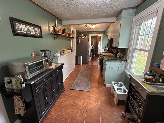 a kitchen with granite countertop a stove and a refrigerator
