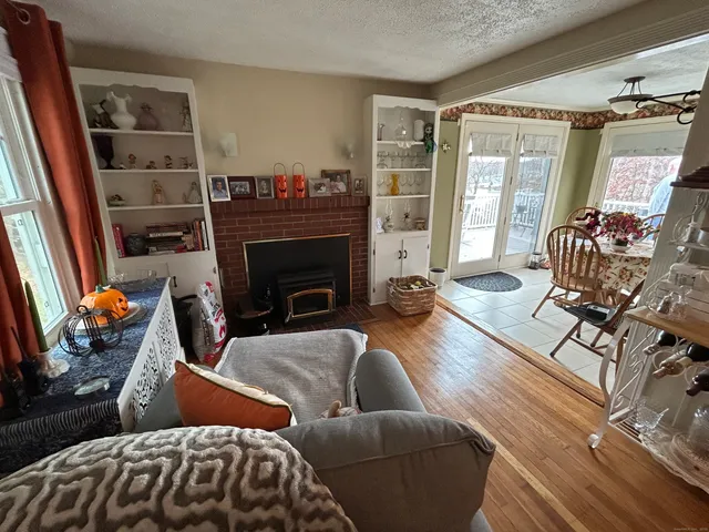 a living room with furniture a fireplace and a floor to ceiling window