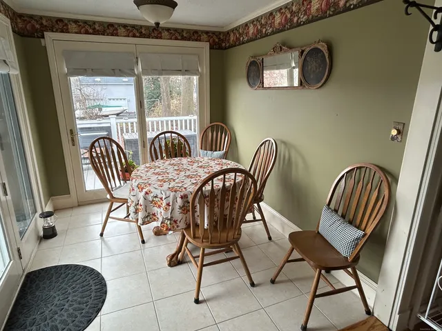 a view of a dining room with furniture and windows