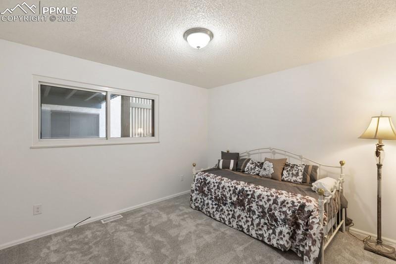 938 Fontmore Road, Unit B Colorado Springs, CO 80904 - Photo 12 of 30 a bedroom with a bed and window