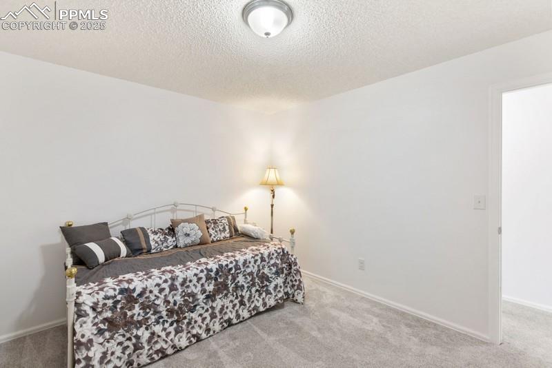 938 Fontmore Road, Unit B Colorado Springs, CO 80904 - Photo 13 of 30 a bedroom with a bed and a night stand