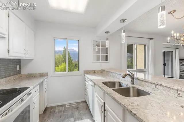 a kitchen that has a sink and a stove