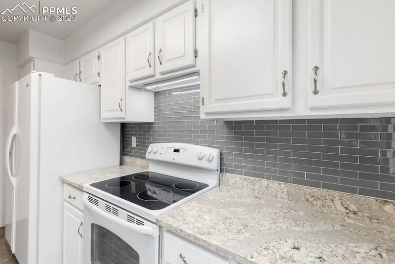 938 Fontmore Road, Unit B Colorado Springs, CO 80904 - Photo 18 of 30 a kitchen with granite countertop white cabinets and white appliances
