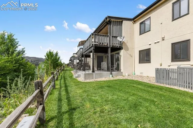 a view of a house with a yard and furniture