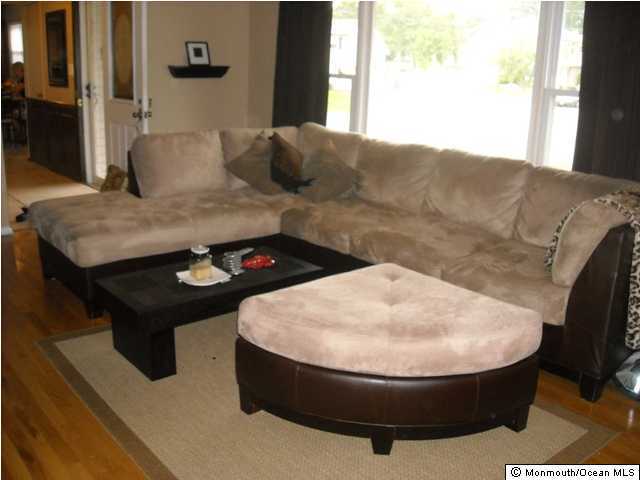 9 Newbury Road Howell, NJ 07731 - Photo 2 of 3 a living room with furniture and a fireplace
