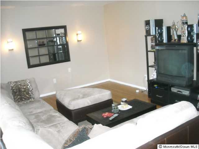 9 Newbury Road Howell, NJ 07731 - Photo 3 of 3 a living room with furniture and a lamp
