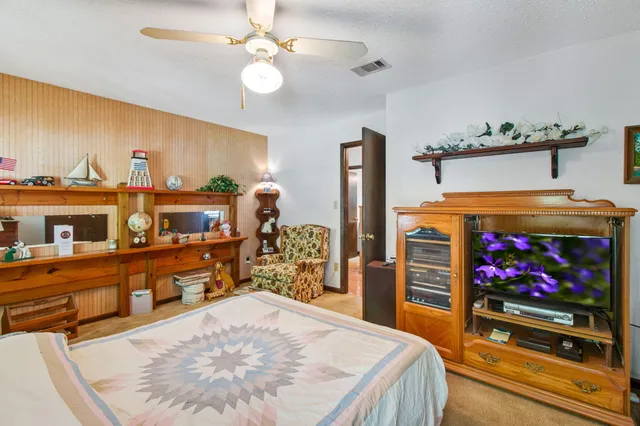 a bed room with a bed and a flat screen tv