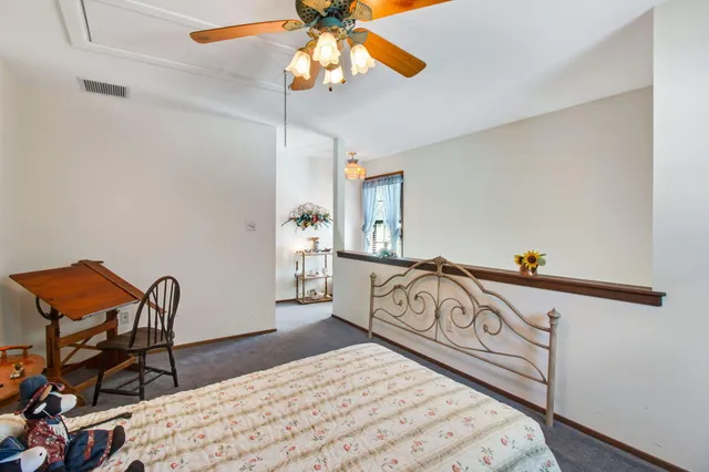 a bedroom with furniture and a ceiling fan