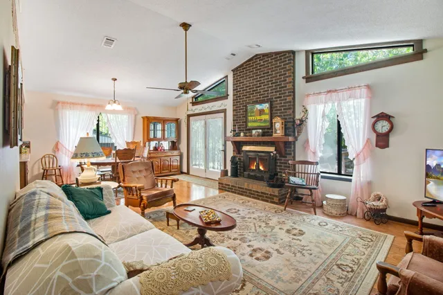 a living room with furniture a fireplace and a chandelier