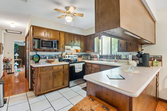 a kitchen with a stove a sink a dining table and chairs