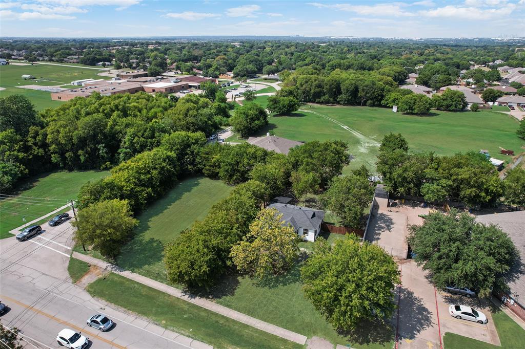 403 East Parkerville Road DeSoto, TX 75115 - Photo 3 of 6 an aerial view of green landscape with trees houses and lake view