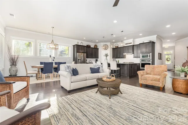 a living room with fireplace furniture and a wooden floor