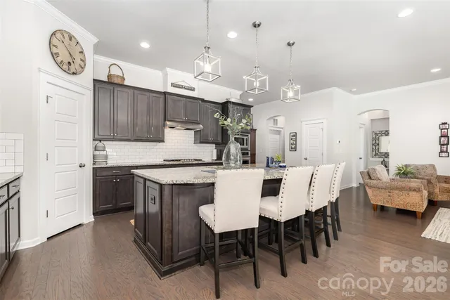 a large kitchen with a table and chairs