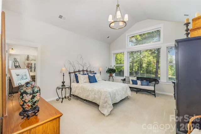 a bedroom with bed and a large window