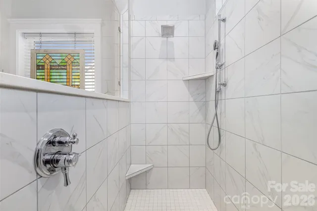 a bathroom with a window and a shower