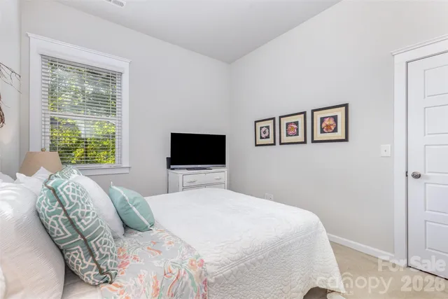 a bedroom with a large bed and a television