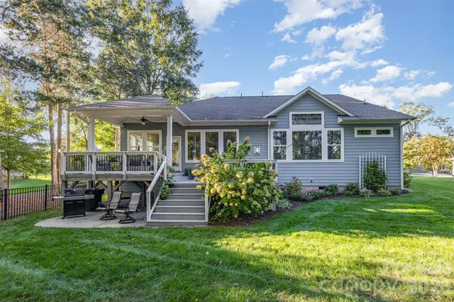 a front view of a house with a yard table and chairs