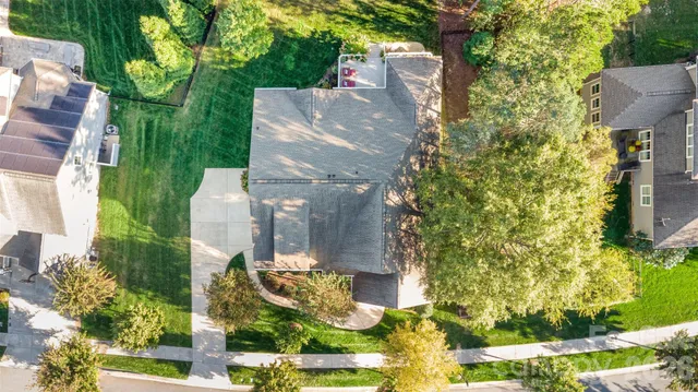 a view of backyard with swimming pool and green space