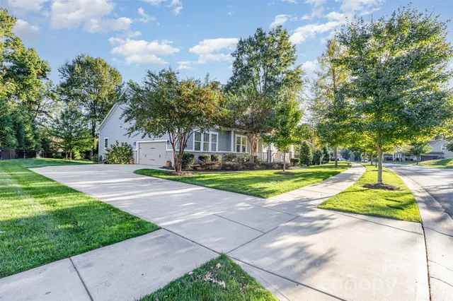 an aerial view of a residential houses with yard