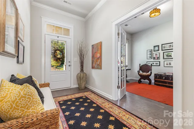a bedroom with furniture and a rug