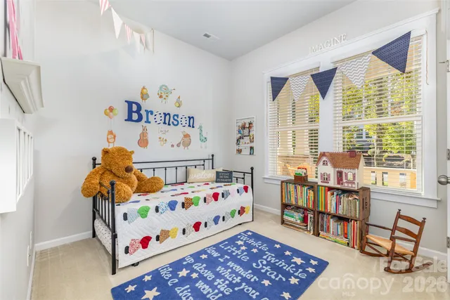 a bedroom with baby toys and a window