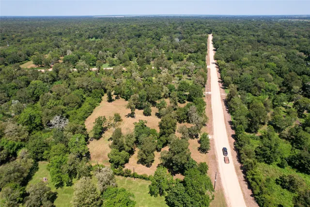 an aerial view of a house with a yard and garden