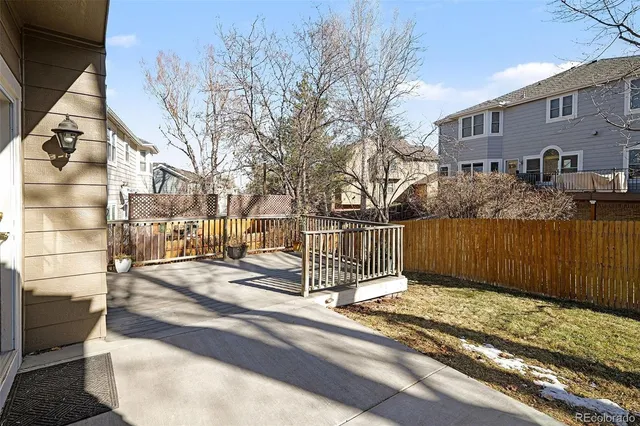 a view of a building with a wooden fence
