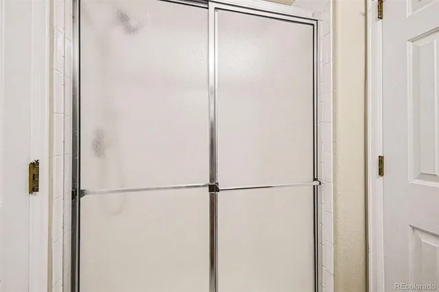 a bathroom with a glass shower door