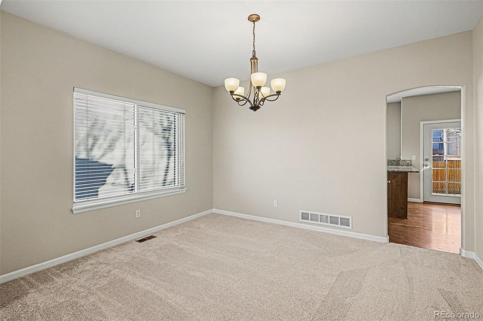 8046 Lodgepole Trail Lone Tree, CO 80124 - Photo 19 of 34 a view of livingroom with chandelier fan and windows