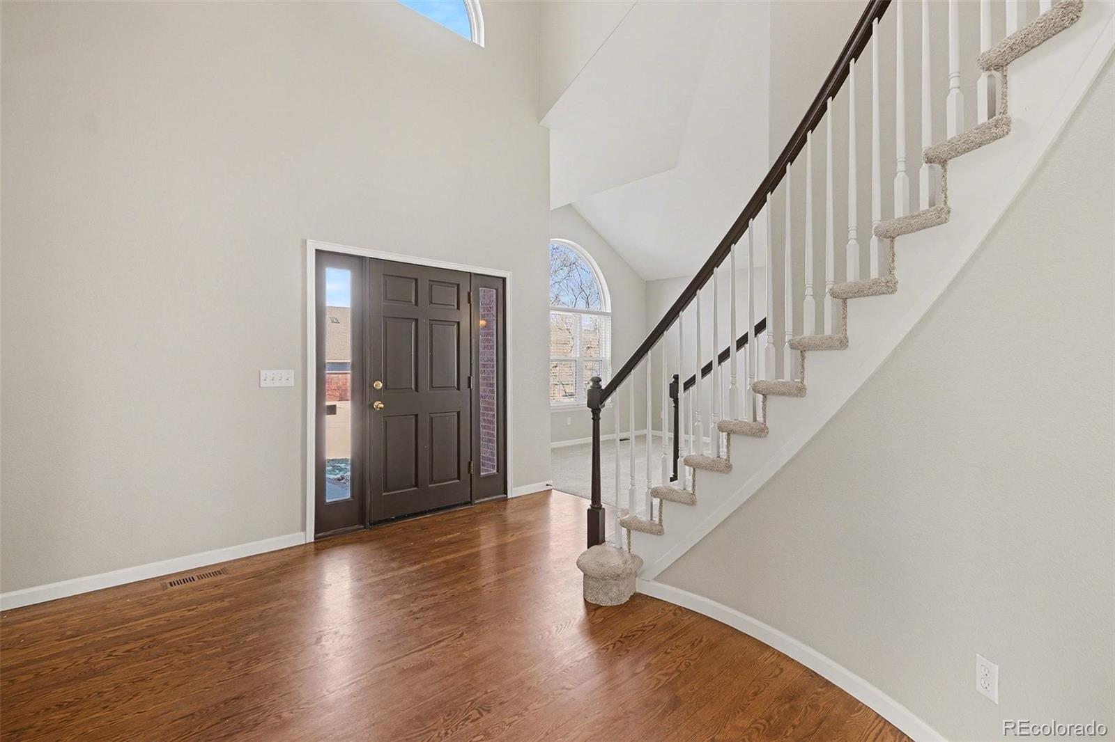 8046 Lodgepole Trail Lone Tree, CO 80124 - Photo 20 of 34 a view of staircase with wooden floor and stairs