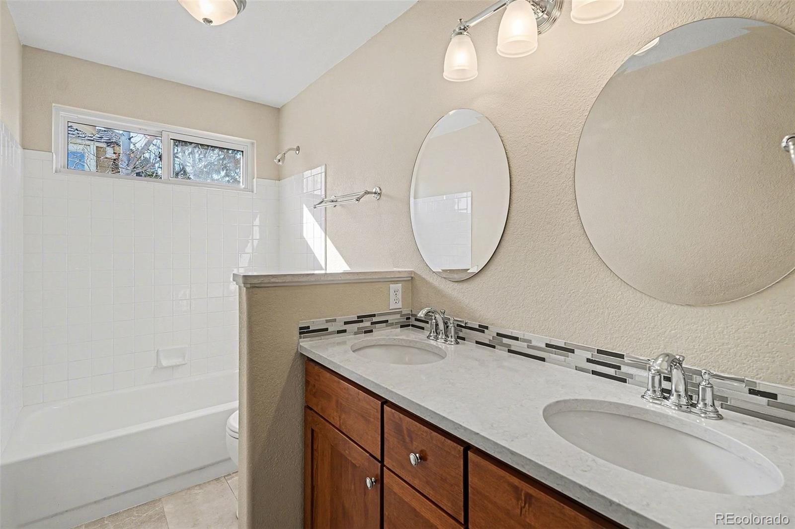 8046 Lodgepole Trail Lone Tree, CO 80124 - Photo 26 of 34 a bathroom with a sink double vanity and a mirror