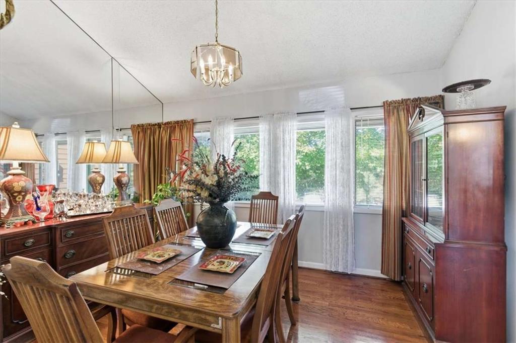 1509 High Point Road Bowdon, GA 30108 - Photo 14 of 47 a dining room with furniture a chandelier and wooden floor
