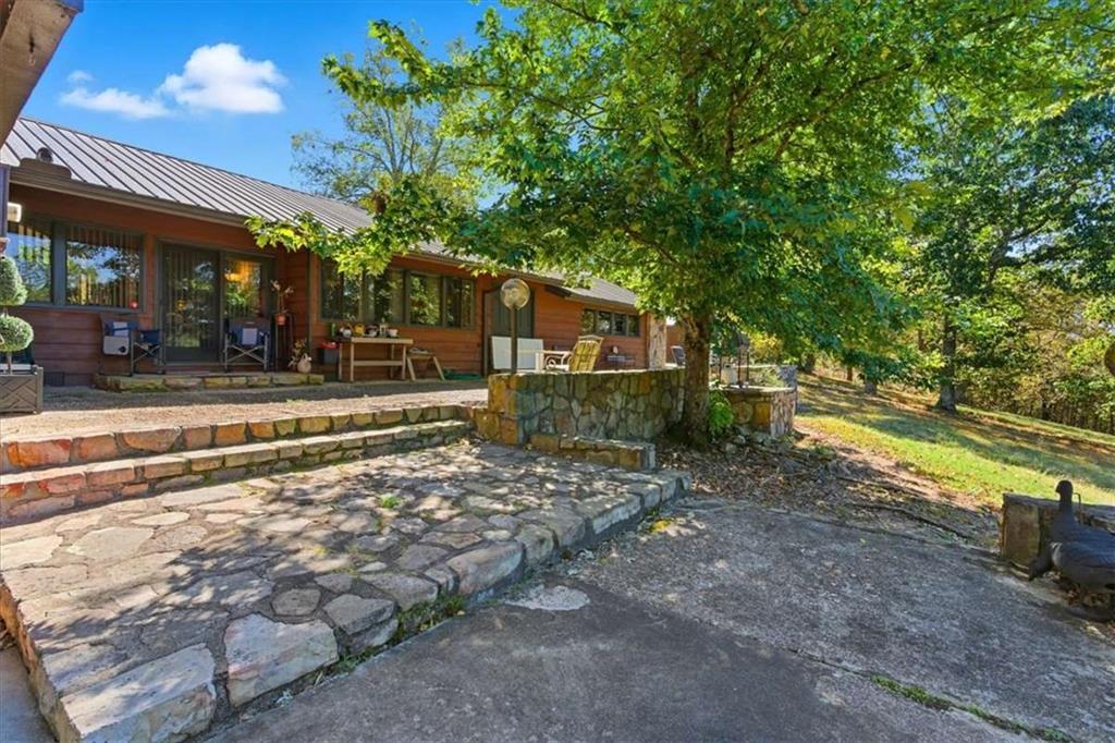 1509 High Point Road Bowdon, GA 30108 - Photo 36 of 47 a view of a house with large trees and a small yard