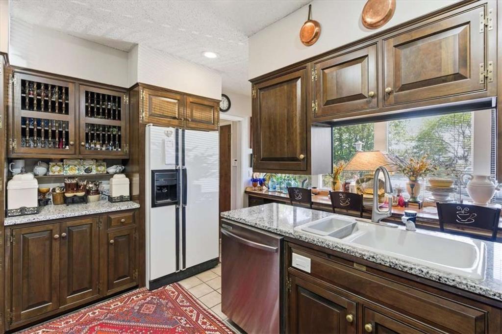 1509 High Point Road Bowdon, GA 30108 - Photo 10 of 47 a kitchen with stainless steel appliances granite countertop a sink a stove and a refrigerator