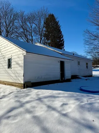 a view of backyard with wooden fence and large trees