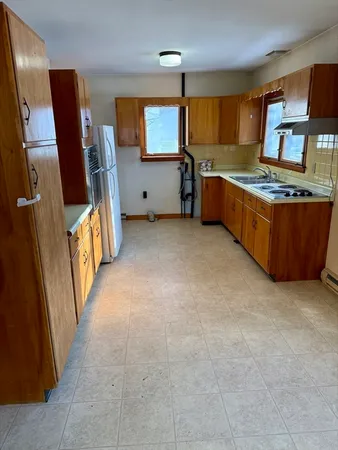 a view of kitchen with furniture and electronic appliances