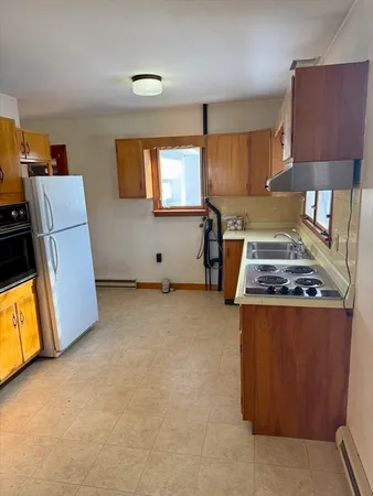 a kitchen with furniture and a stove top oven