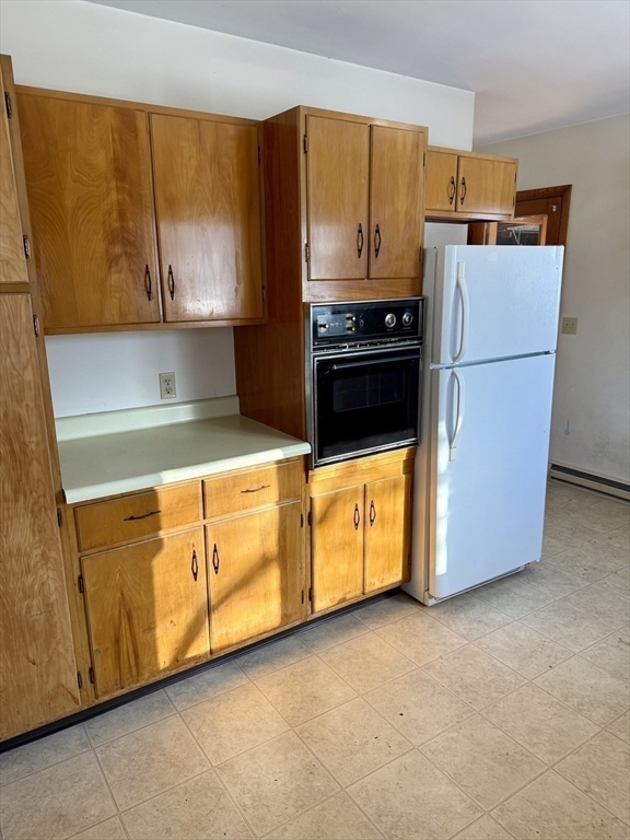 10 Center Road Gill, MA 01354 - Photo 7 of 16 a kitchen with wooden cabinets and a stove top oven
